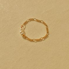 This dainty pearl ring is handcrafted with 14k gold filled Figaro chain and mini freshwater pearls. Its simplicity made it a perfect stackable ring. The gold filled material is tarnish-free and never turns your fingers green!  Shop the matching earring, necklace and bracelet here: https://www.etsy.com/ca/listing/1041079879/mini-freshwater-pearl-and-figaro-chain https://www.etsy.com/ca/listing/938893891/mini-freshwater-pearl-choker-14k-gold https://www.etsy.com/ca/listing/1019412027/mini-freshwat Everyday Gold Ring With Pearl Charm, Dainty Hypoallergenic Pearl Ring For Everyday, Dainty Everyday Hypoallergenic Pearl Ring, Dainty Stackable Pearl Jewelry, Dainty Adjustable Pearl Stackable Rings, Dainty Adjustable Gold Pearl Ring, Dainty Gold Stackable Pearl Rings, Dainty Yellow Gold Pearl Ring For Everyday, Dainty Tiny Gold Pearl Ring