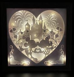 a lighted heart with an image of a castle in the middle