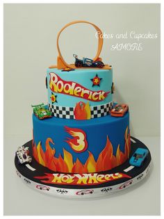 a three tiered cake with cars and flames on it