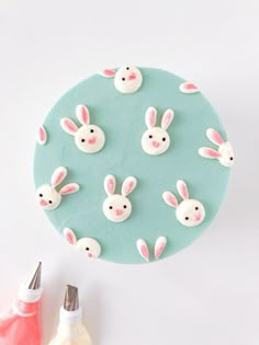 a blue plate with white bunny ears on it and some pink paint next to it