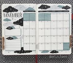 an open planner with clouds and the words november written in black ink on top of it