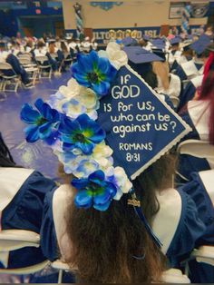 a woman wearing a graduation cap with flowers in her hair and the words god is for us who can be against us?