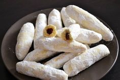 some food is on a black plate with white powdered sugar and raisins