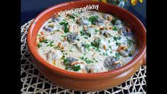 a bowl filled with food sitting on top of a table