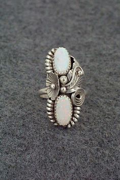 This opalite and sterling silver ring was made by Navajo silversmith Max Calladitto. The inside of the band is signed Max C and stamped sterling.Size: 6.5Length: 1 1/4"Width: 1/2"Free shipping on all orders! We ship with USPS and always include tracking. All orders ship within a day of payment.Returns are accepted up to 30 days after you receive your order. Just send us a message. Our shop offers cash back or store credit. The item must be returned in new condition. Silver Southwestern Style Wedding Ring, Southwestern Style Silver Wedding Rings, Southwestern Style Oval White Rings, Vintage Silver Multi-stone Opal Ring, Handmade White Opal Ring In Sterling Silver, Collectible Sterling Silver Opal Ring Stamped 925, Silver Opal Jewelry For Collectors, Handmade Southwestern Opal Ring, Collectible Silver Opal Jewelry