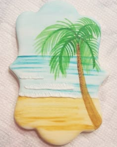 a cookie shaped like a palm tree on the beach