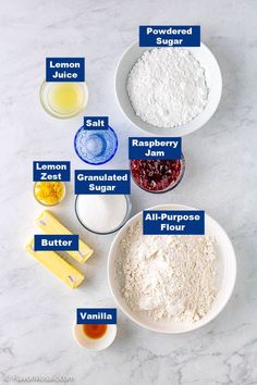 ingredients to make lemon cake laid out on a white counter top, including flour, sugar, jam, and butter