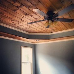 a ceiling fan is mounted to the side of a room