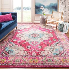 a living room filled with furniture and a pink rug