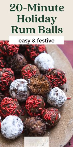 a plate full of chocolate covered balls with red and white sprinkles on top