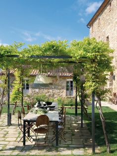 an outdoor dining area with table and chairs