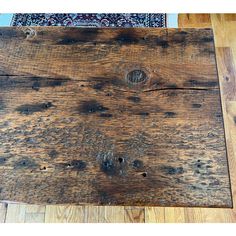 an old wooden table with wood grains on the top and flooring around it