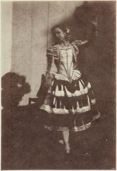 an old photo of a woman in a dress