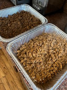 two pans filled with food sitting on top of a counter