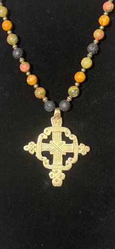 Handmade Ethiopian Coptic cross pendant, hand beaded on synthetic sinew with gemstones, brass, and wood beads. Coptic Cross, Prado, Hand Beading, Wood Beads, Cross Pendant, Charm Necklace, Cross Necklace, Necklace Etsy, Etsy Accessories