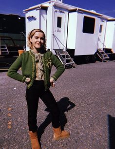 a woman standing in front of a white trailer