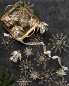 gold christmas decorations with ribbons and bows on a table