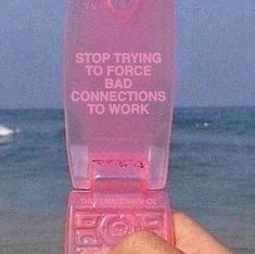 someone is holding up a pink cell phone at the beach and it says, stop trying to force bad connections to work