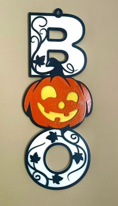 the letter b is decorated with pumpkins and leaves