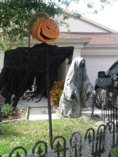 two halloween decorations in front of a house