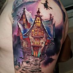 a man with a tattoo on his back has a house and bats in the sky