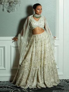 This ivory bridal lehenga set exudes elegance with intricate silver embroidery on a sleeveless blouse, a flowing lehenga skirt, and a sheer, delicately embroidered dupatta. Perfect for brides seeking a timeless and graceful look. Key Features: Color: Chiffron Off-White Components: Sleeveless blouse, full lehenga skirt, and sheer embroidered dupatta Design: Floral and geometric embroidery covering the entire set Dupatta: Sheer with embroidered edges for an elegant drape Occasion: Perfect for wedd Buy Lehenga Online, Indian Bridal Couture, Reception Gowns, Elegant Veils, Mehendi Outfits, Lehenga Online, Buy Sarees Online, Green Lehenga, Bridal Lehenga Red