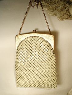 Offering a gorgeous vintage 1940s - 1950s era warm ivory/light champagne mesh Art Deco flapper purse made by Whiting & Davis in near PRISTINE vintage condition and perfect for the Bride! If you've ever seen one of these purses in person you know just how well made they are. The mesh has a wonderful fluidity and movement so it shimmers as it catches the light. I love the SO 1920's Art Deco flapper design of this one. The frame is a beautiful textured/brushed gold on the front and back and shiny gold along the edges. Photos don't begin to do this bag justice or capture the sparkle of the mesh or frame adequately.  The bag measures 7.5 inches (19.1 cm) high, not counting the clasp, and is 5 1/2 inches (13.9 cm) wide along the bottom so it will easily fit your essentials including your phone. Vintage Beige Party Bag, Elegant White Evening Bag For Vintage Events, Retro Beige Party Bag, Vintage Rectangular Wedding Bags, Retro Beige Bag For Party, White Vintage Party Bag, Vintage Cream Bag For Wedding, Vintage White Party Bags, Cream Rectangular Evening Bag