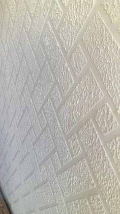 the ceiling is covered in white paint and has many small squares on top of it