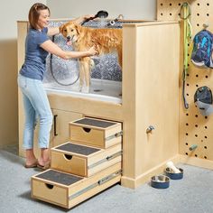 a woman washes her dog in the bathtub while she stands on top of it