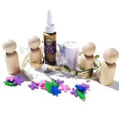 a group of wooden pegs sitting on top of a table next to a bottle of glue