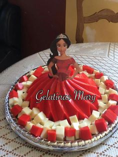 a cake that has been decorated to look like a woman in a red dress with white squares on it