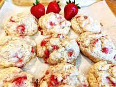 a bunch of strawberry shortcakes sitting on top of a paper towel next to some strawberries