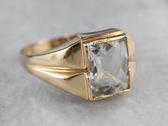 This Retro Era ring is full of refined sophistication! The white topaz at the center is pineapple cut for maximum sparkle and shine. Sleek shoulders and subtle milgrain on the bezel setting are particularly nice details! Metal: 10K Yellow Gold Gem: White Topaz approximately 4.00 Carats Gem Measurements: 7.9 x 9.8 mm, Rectangle Pineapple Cut Ring Size: 10.25 Marks: "10K" Stamped on the inside band Luxury Topaz Baguette Cut Ring For Formal Occasions, Luxury Formal Baguette-cut Topaz Ring, Luxury Formal Baguette Cut Topaz Ring, Classic White Gold Baguette Cut Topaz Ring, Classic Signet Ring With Center Stone, Formal 14k Gold Baguette Cut Topaz Ring, Formal Baguette Cut Topaz Ring In 14k Gold, Classic Emerald-cut Topaz Ring For Wedding, Classic Emerald Cut Topaz Ring For Wedding