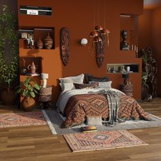 a bedroom with orange walls and wooden floors