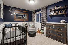 a baby's room is decorated in blue and white with lots of storage space