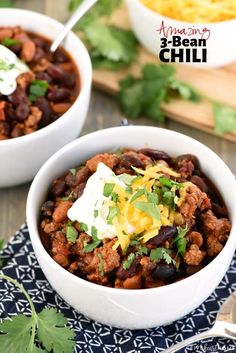 two white bowls filled with chili and beans