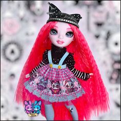 a doll with red hair wearing a tiara and holding a stuffed animal in her hand