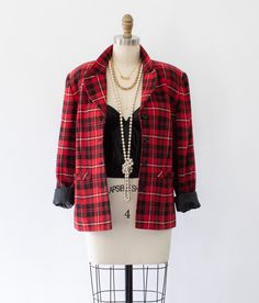 Vintage 80s boxy plaid blazer. Featuring a boxy structured fit, this piece blends preppy elegance with a classic plaid print in shades of red and black. Notched collar. Padded shoulders. Long sleeves. Front welt pockets. Front button closure. The measurements provided give a good idea of the fit, but please note that vintage sizing can vary, so it's always best to compare the measurements to a similar item in your own wardrobe to ensure a good fit.  * Brand: Norton McNaughton * Decade: 1980s * Fabric: 30% Wool, 40% Acrylic, 25% Polyester, 5% Other Fiber * Lining: 100% Polyester * Color: Red Plaid * Condition: Excellent vintage condition, minimal signs of wear S I Z E + F I T * Length: 25.5" * Bust: 40" / 41" * Waist: 37" * Hip: - * Shoulders: 16" * Sleeves: 23"  * Marked Size: 8 * Estimate Retro Plaid Blazer For Work, Womens Blazers, Plaid Blazer, Plaid Jacket, Style Expert, Jacket Vintage, Notched Collar, Plaid Print, Shades Of Red