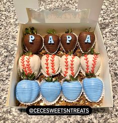 a box filled with chocolate covered baseballs and strawberries