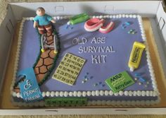 an old age survival kit cake is displayed in a cardboard box on the floor,