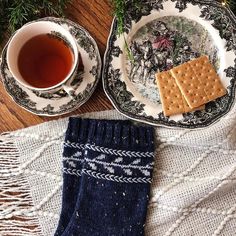 two plates with crackers and a cup of tea