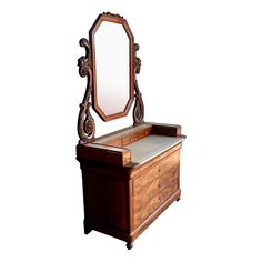 an antique wooden dressing table with mirror on top