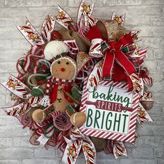 a christmas wreath with a gingerbread man holding a sign that says baking is bright