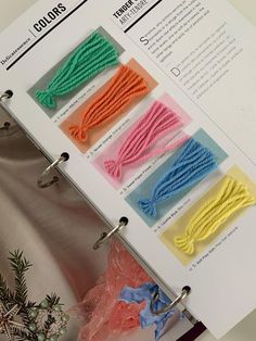 an open book with different colored string on it