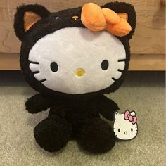 a hello kitty stuffed animal with a bow on its head