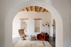 a living room filled with furniture and white walls