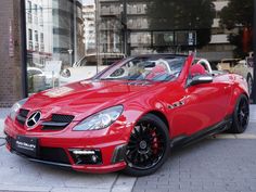 a red sports car parked in front of a building