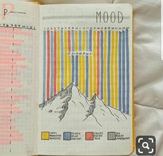 an open notebook with colorful lines and mountains