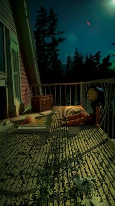 a person sitting on a porch at night