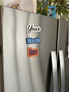 a stainless steel refrigerator with stickers on the door saying your words here and penguin